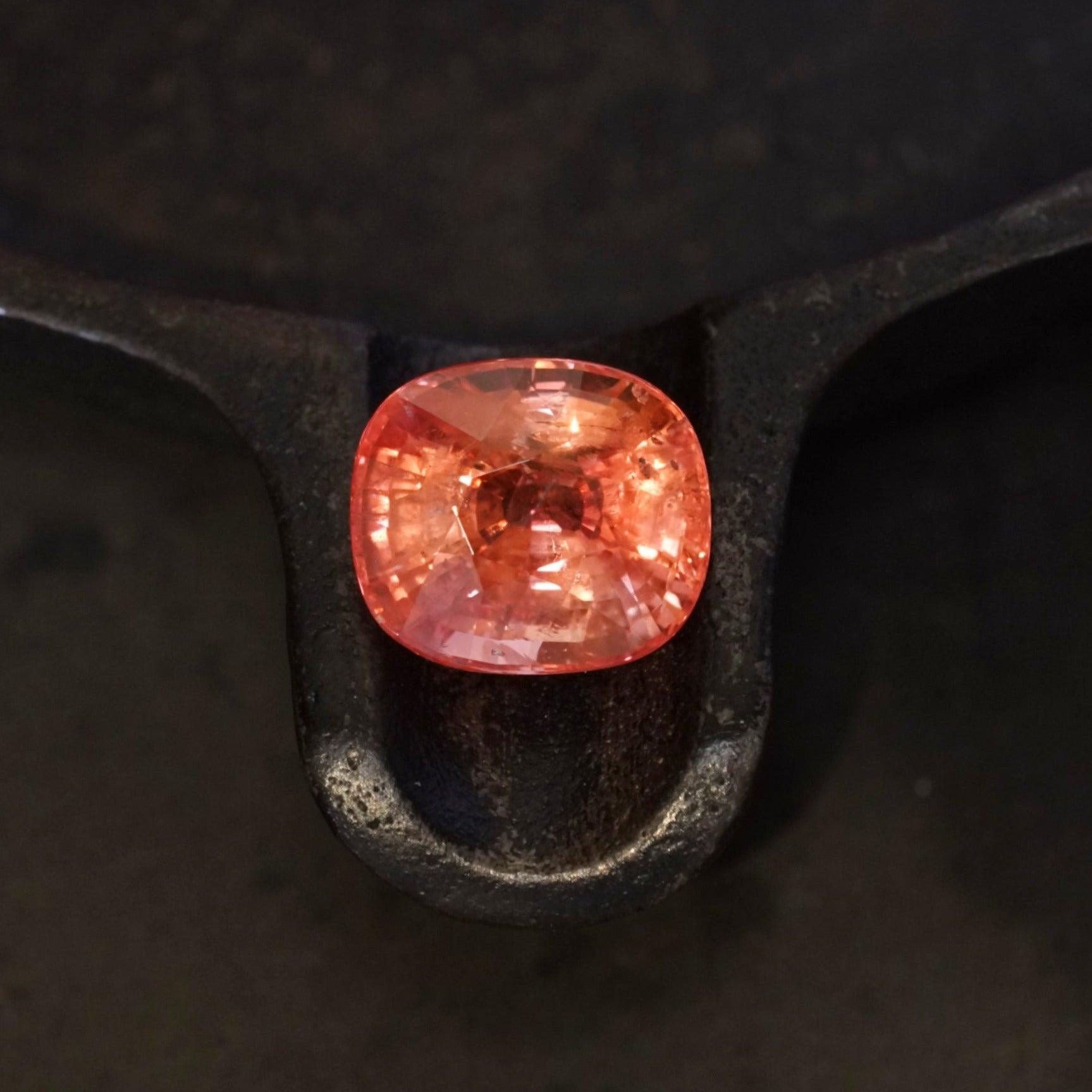 An 11.31-carat, cushion-shaped, unheated padparadscha sapphire from the Jogani collection.