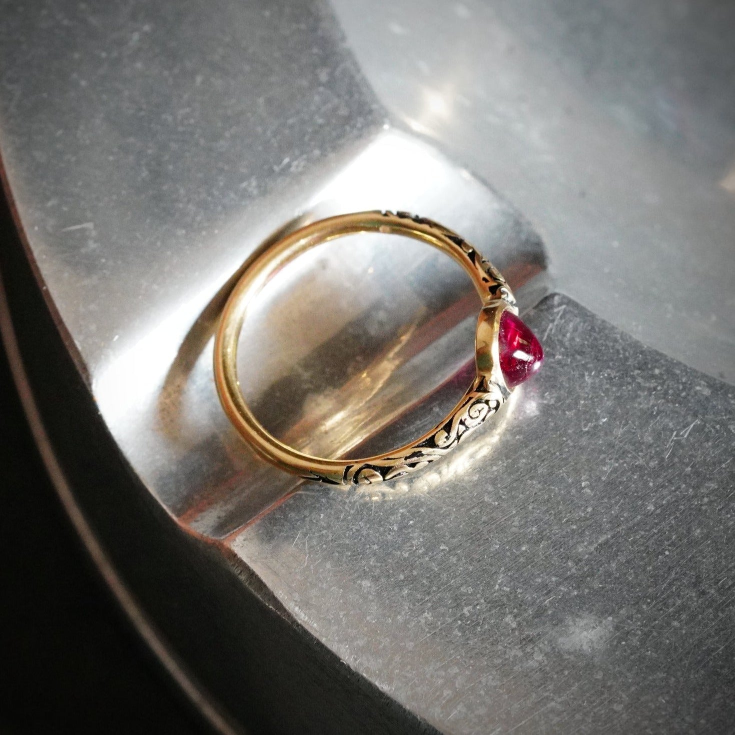 Timeless yet contemporary, this handcrafted Jogani ring showcases a 0.96 ct vivid red Burmese ruby, no heat, set in an elegant open bezel of 18K gold.