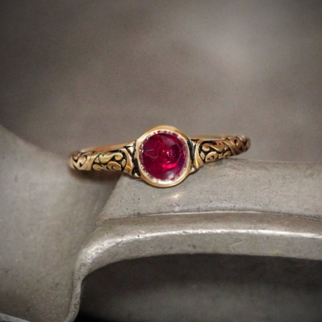 A mesmerizing 0.96 ct no-heat Burma ruby, glowing in vivid red, is elegantly cabochon-cut and bezel-set in 18K yellow gold—a Jogani creation that merges history and modern craftsmanship.