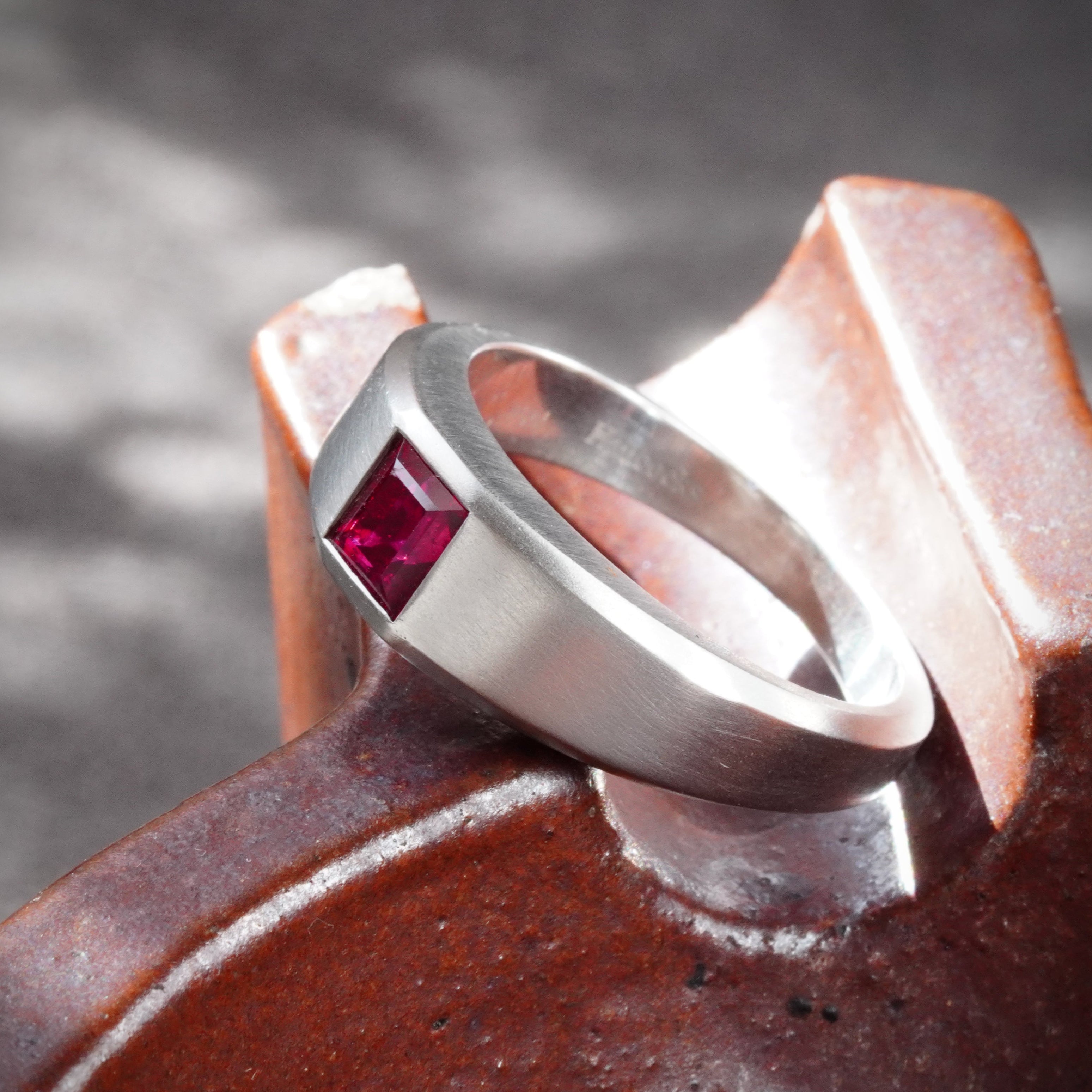 A 1.15-carat step-cut Burmese ruby ring, featuring a clean red gemstone set in a platinum flush setting, presented by Jogani.