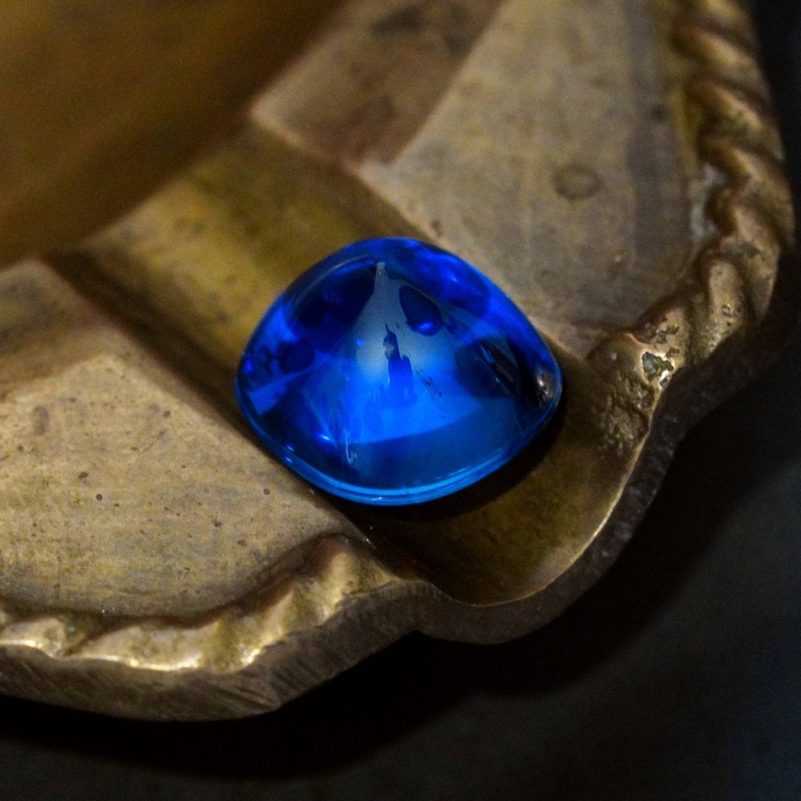 A captivating 10.99 ct no-heat Burma sapphire in a smooth sugarloaf cut, radiating deep blue hues. A rare gem, now available in a ring at Jogani.