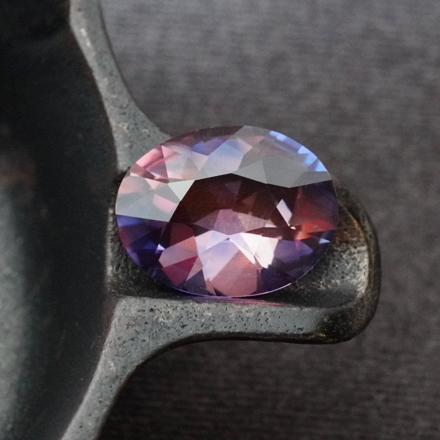 17.65 ct no-heat Winza sapphire from Jogani, showcasing a mesmerizing blend of purple, pink, orange, and blue hues in an elegant oval cut.