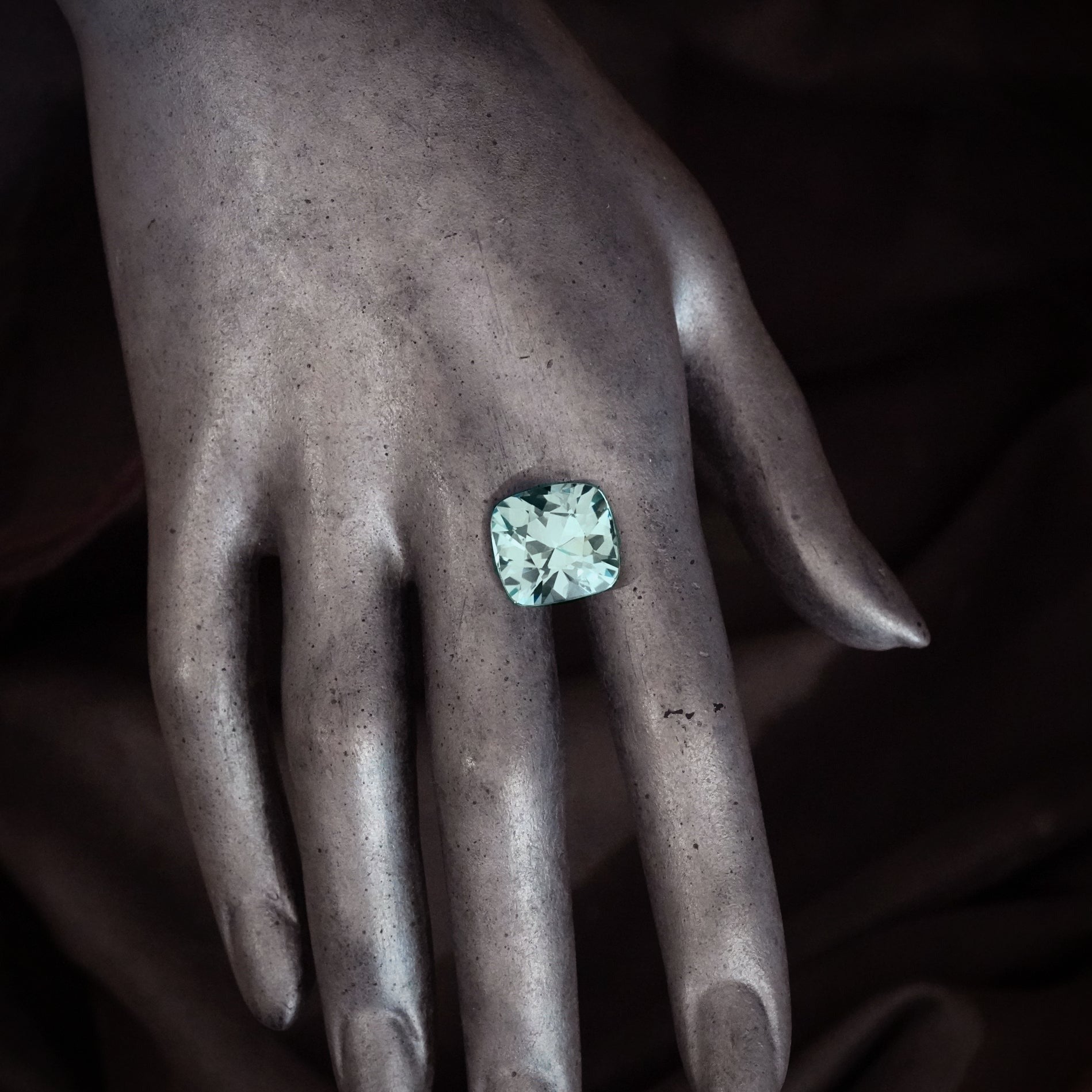 A breathtaking 19.73 ct no-heat sapphire from Burma, beautifully cushion-cut, its bluish-green glow is an opportunity for collectors and designers—offered by Jogani.