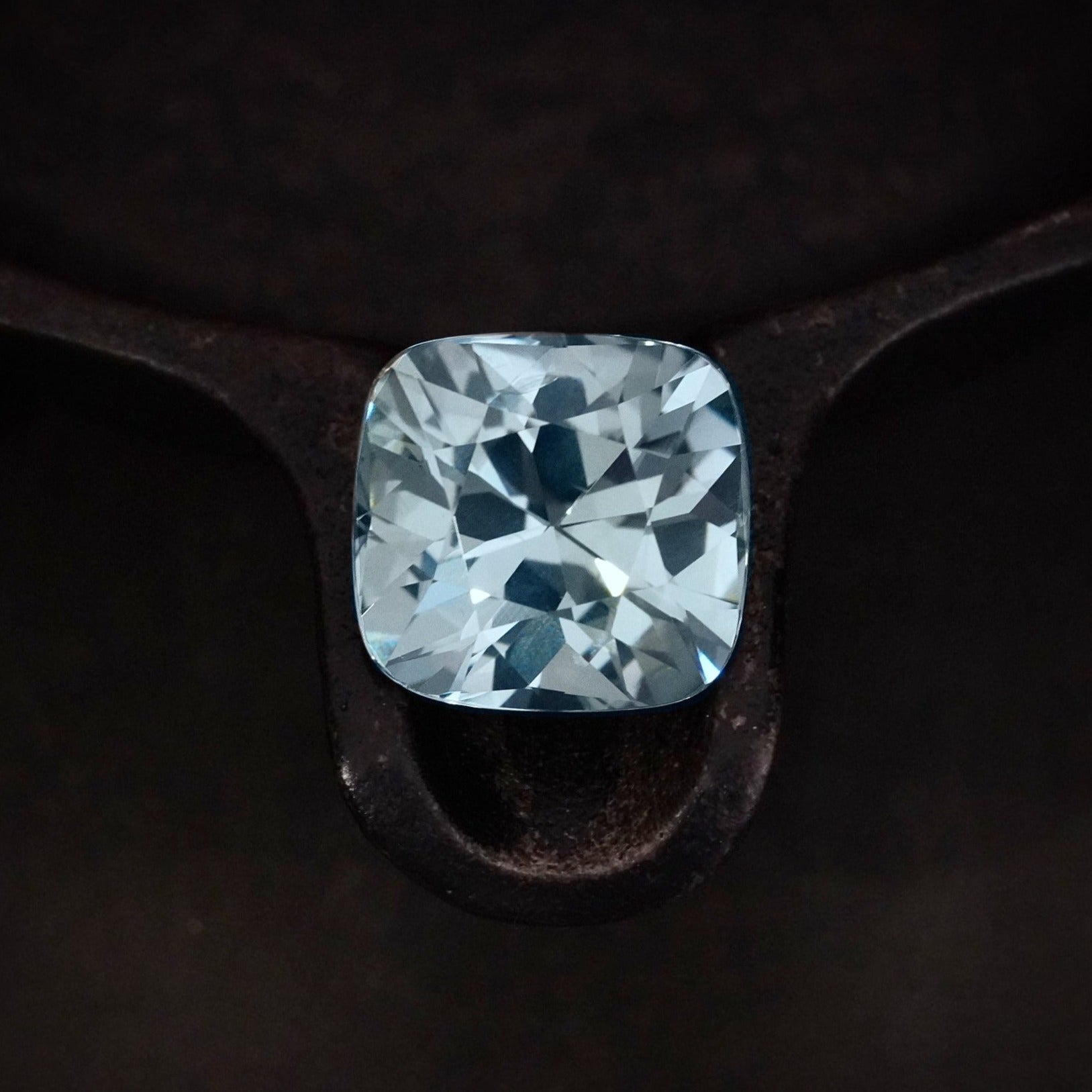 A remarkable 19.73 ct cushion-cut Burma sapphire, no heat, showcasing a mesmerizing bluish-green hue—an elite collector’s gemstone, available with Jogani.