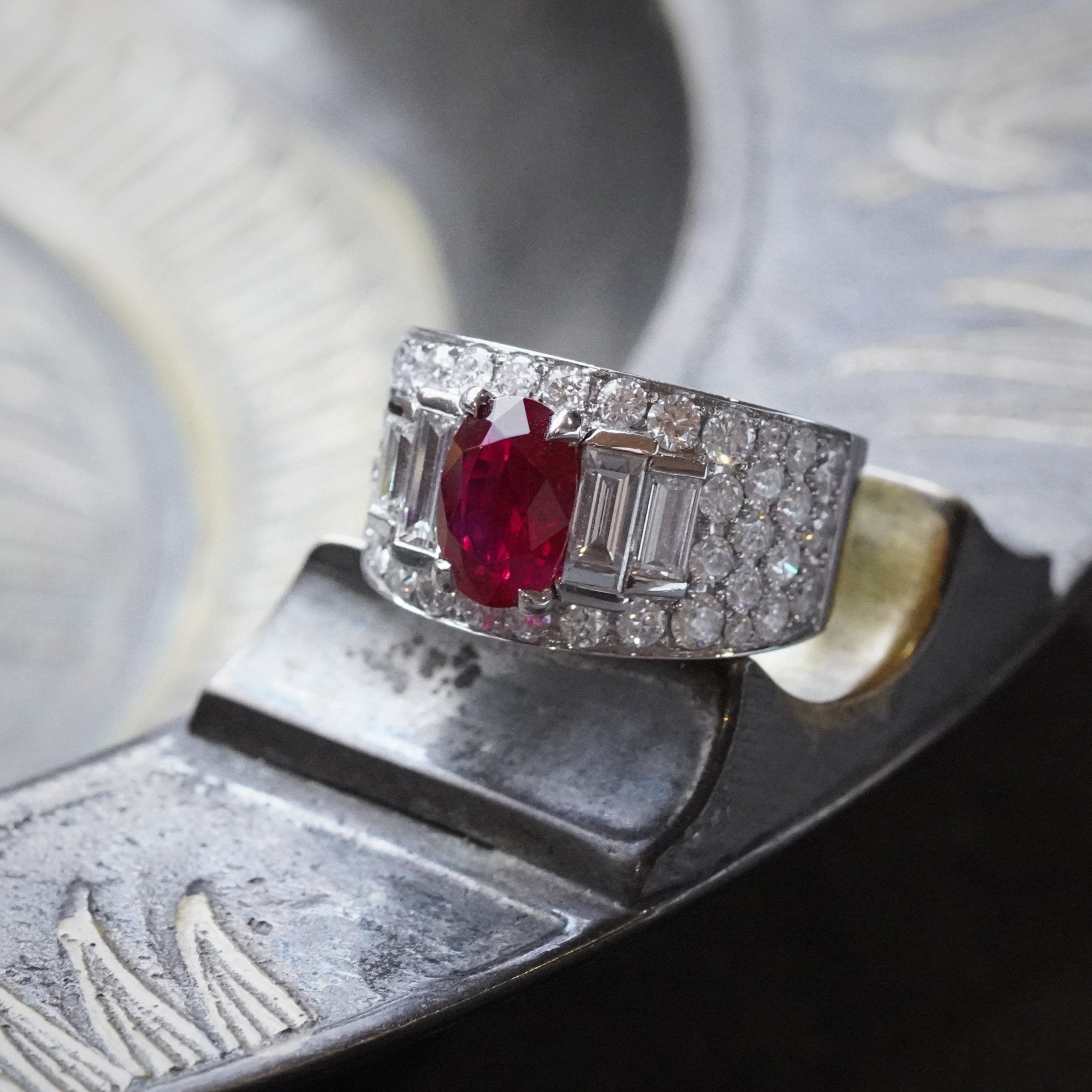 A vivid red, elongated cushion-cut Burmese ruby weighing 2.02 cts, set in a platinum open prong setting, accented by diamonds; crafted by Bulgari. Sold by Jogani.