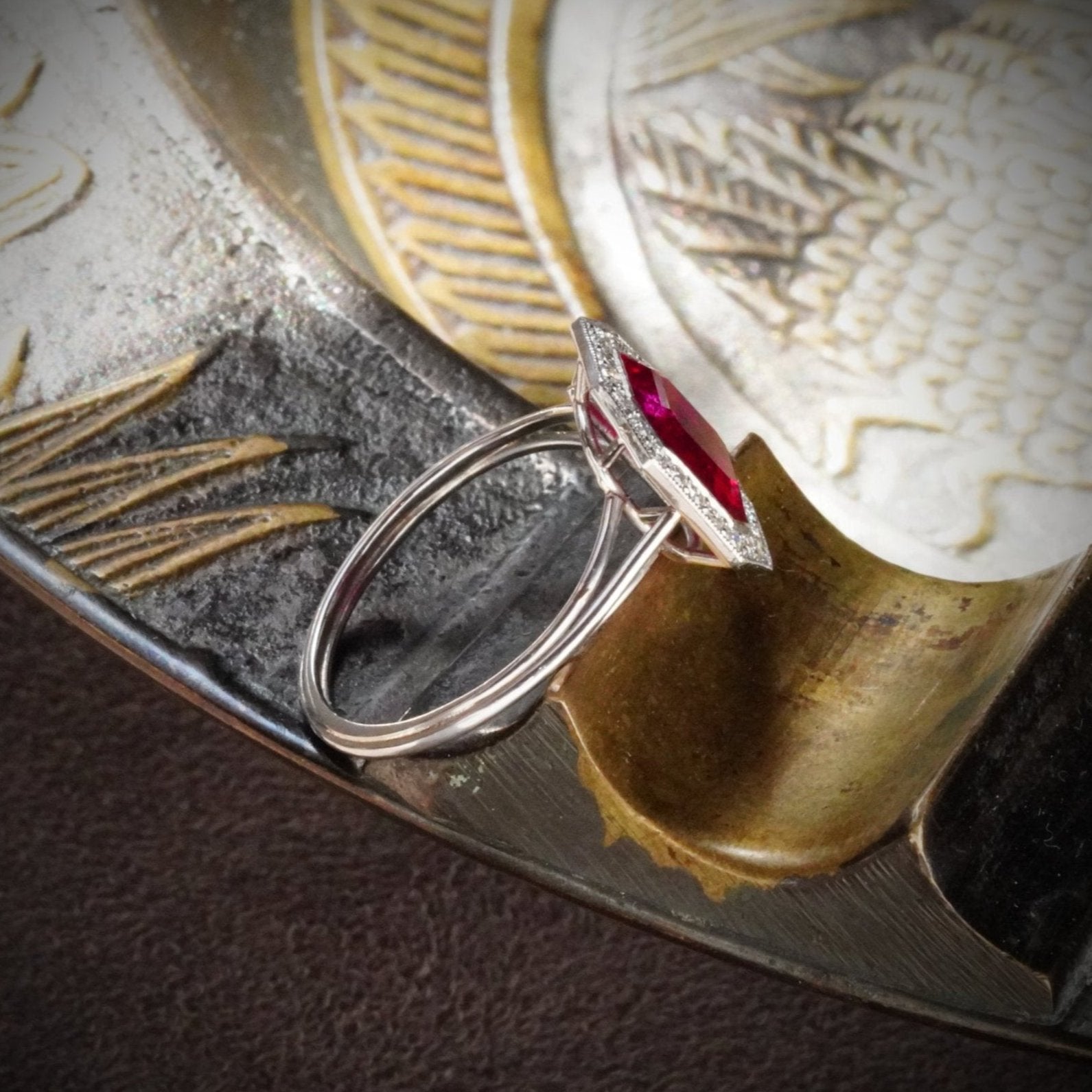 Side view of the refined 2.13 ct Burma ruby ring, available from Jogani. No-heat, step-cut, and framed by diamonds in a masterfully crafted platinum setting.