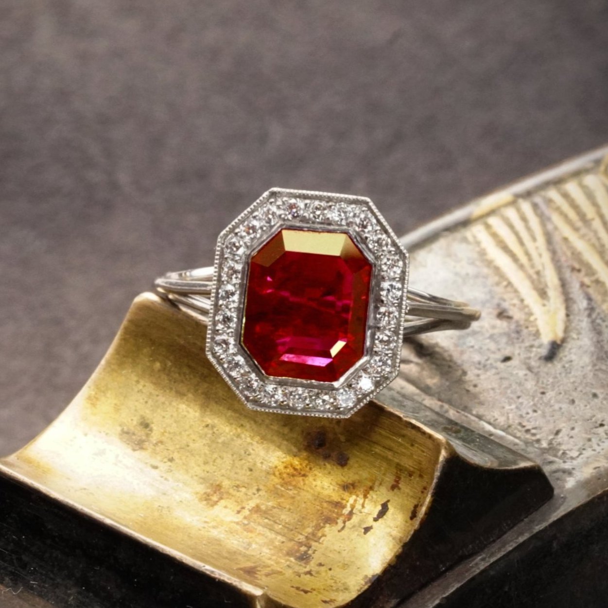 Elegant 2.13 ct step-cut Burma ruby ring from Jogani, featuring a no-heat red ruby in a handcrafted platinum bezel setting with diamond accents.