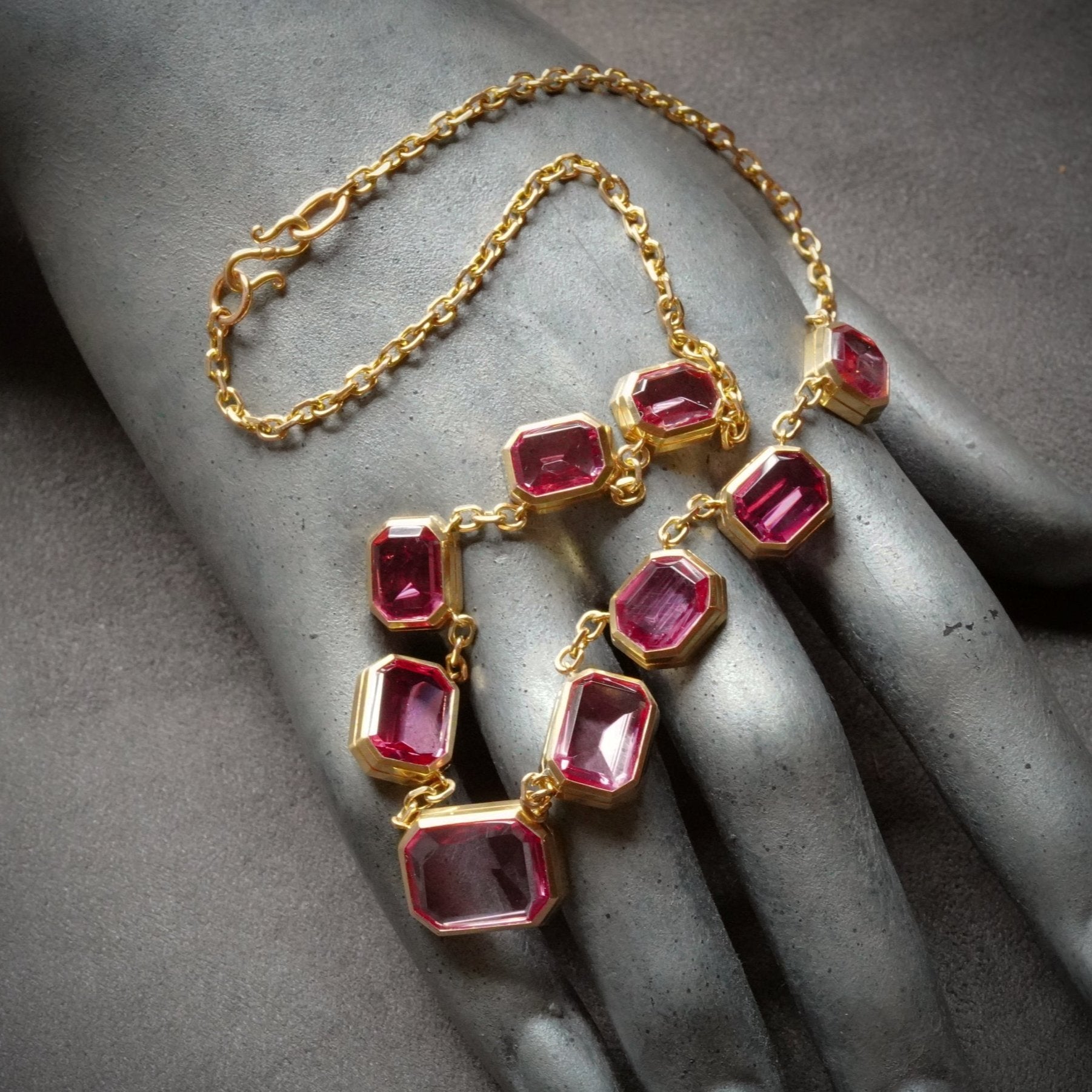 A breathtaking 28.11 TCW step-cut pink Tajikistan spinel necklace, elegantly bezel-set in platinum and 18K rose gold. A distinguished collector’s masterpiece, available at Jogani.