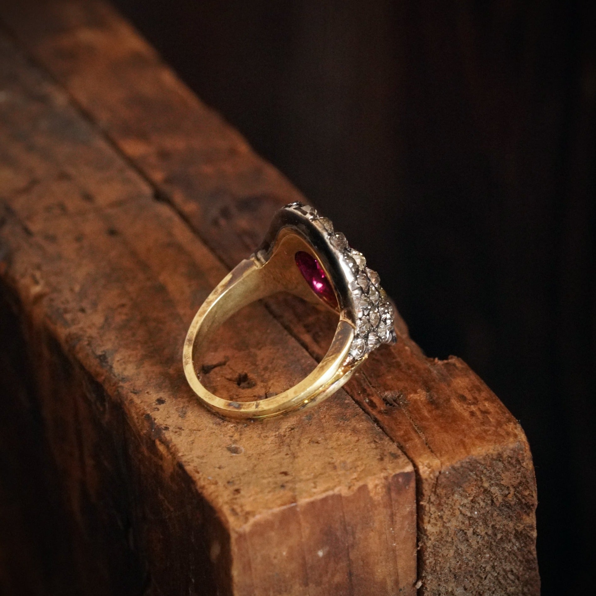 This 3.12 ct Cushion Cut Burma Ruby Ring, set in 18K yellow gold and silver, showcases an unheated, vivid pink-red ruby framed by historic table-cut diamonds. Offered by Jogani.