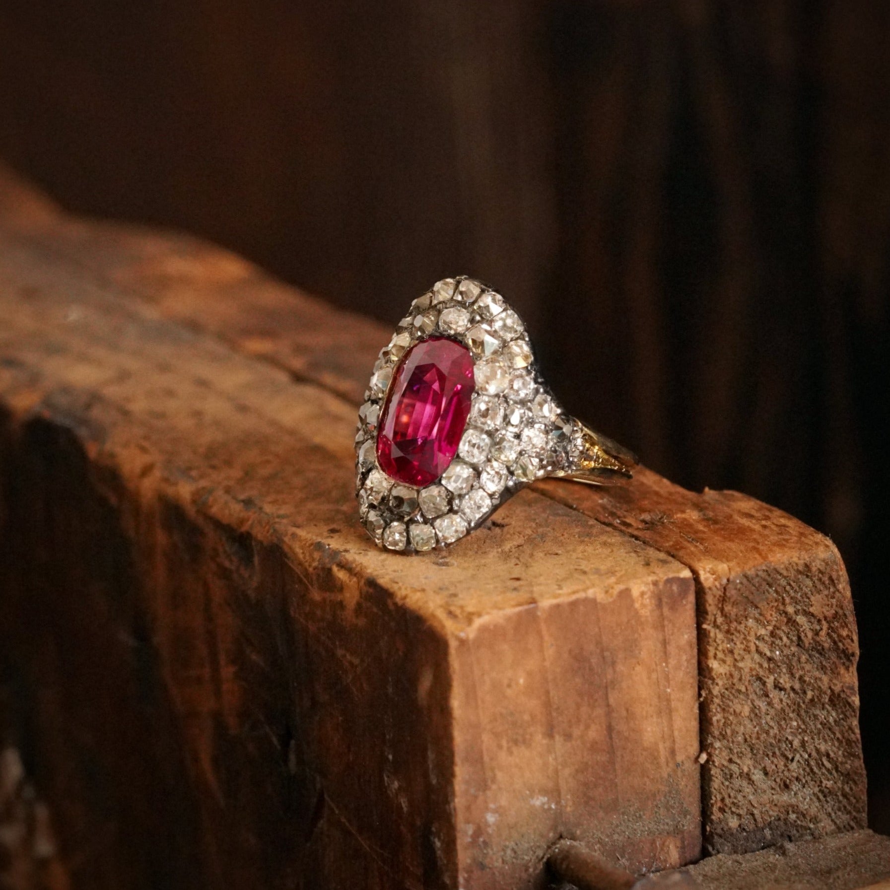 A magnificent 3.12 ct Georgian-era Burma Ruby and Diamond Ring, featuring a no-heat pink-red cushion cut ruby, encircled by antique table-cut diamonds. Available with Jogani.