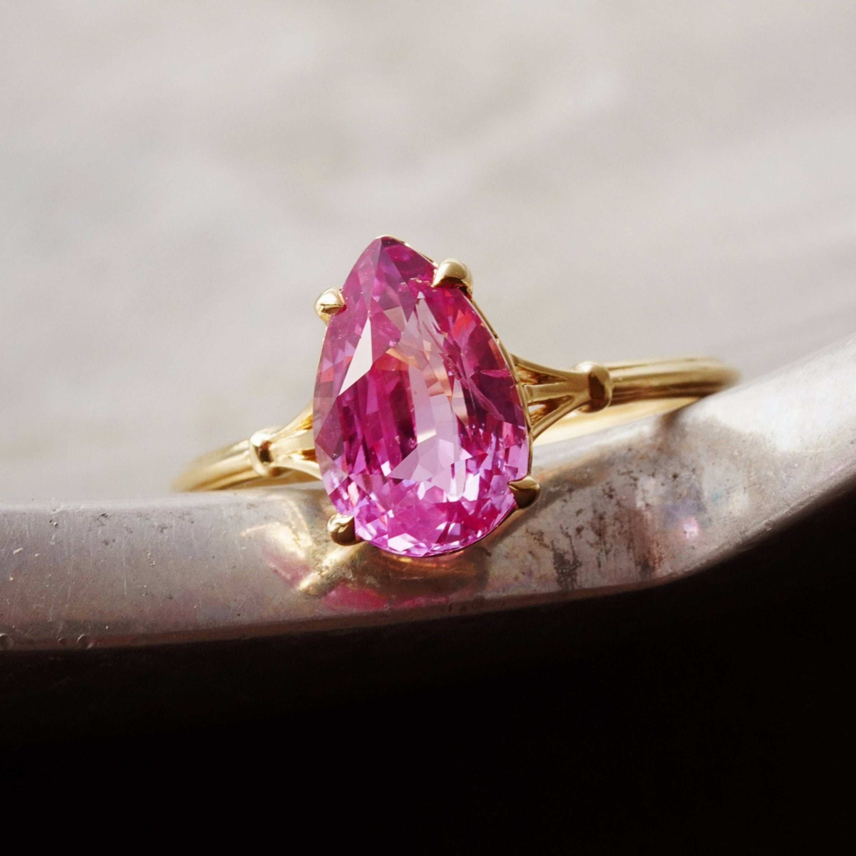 A breathtaking 3.14 ct no-heat Ceylon Padparadscha sapphire, pear cut, glowing with an orangy-pink hue, set in 18K gold—an exceptional creation by Jogani.