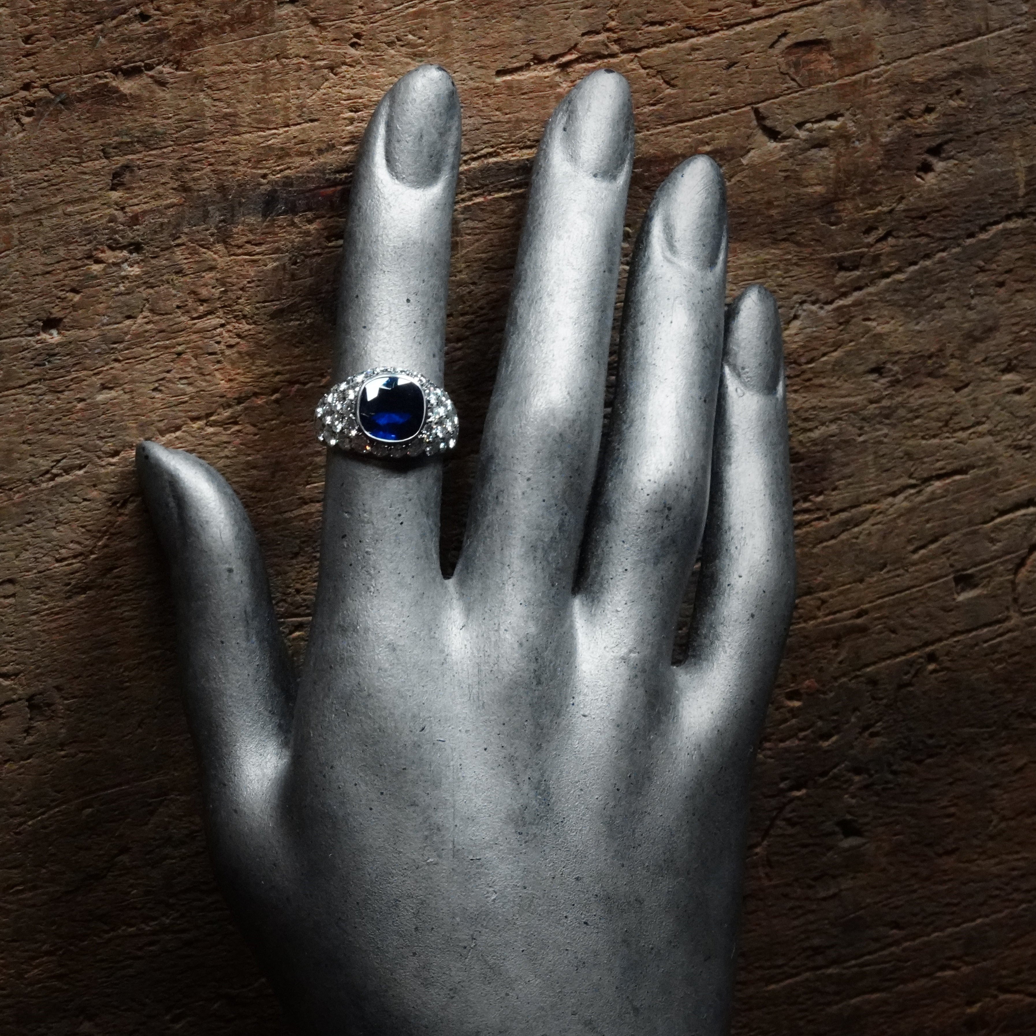 This expertly crafted platinum ring by Jogani features a no-heat, 3.39 ct cushion-cut Burma sapphire, exuding rarity, beauty, and investment value.