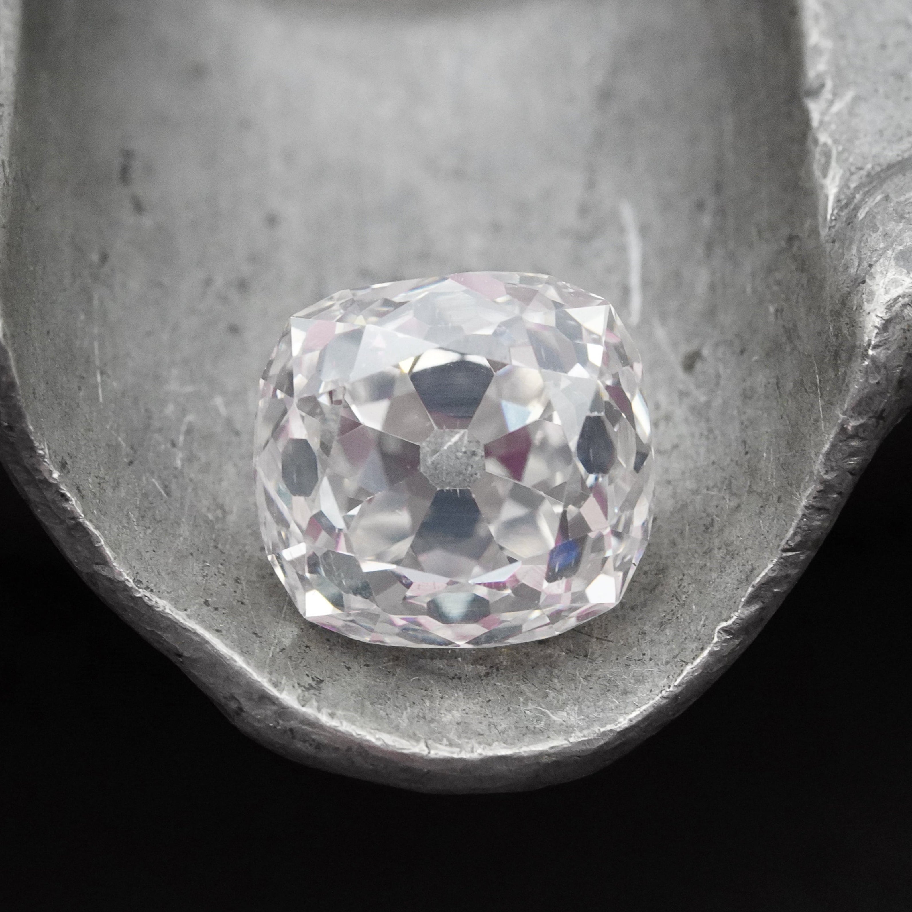 Close-up of a 4.02 ct Old Mine Cut diamond, showcasing its vintage appeal, L color, and VS2 clarity. GIA-certified and full of character, presented by Jogani.