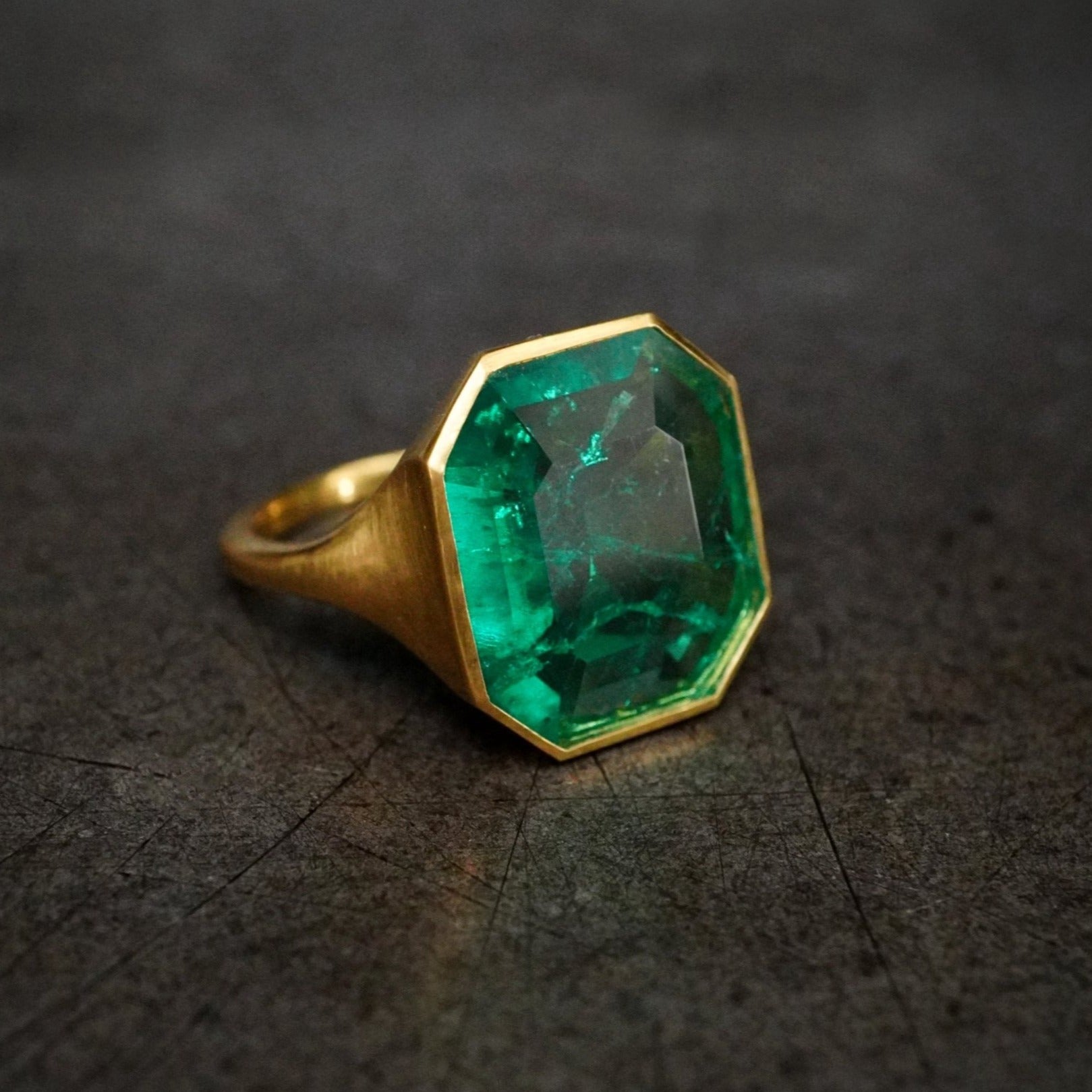 A rare 4.48 ct step-cut Colombian emerald ring, no oil, bezel-set in 20K yellow gold, designed by Jogani for collectors and connoisseurs of fine jewelry.