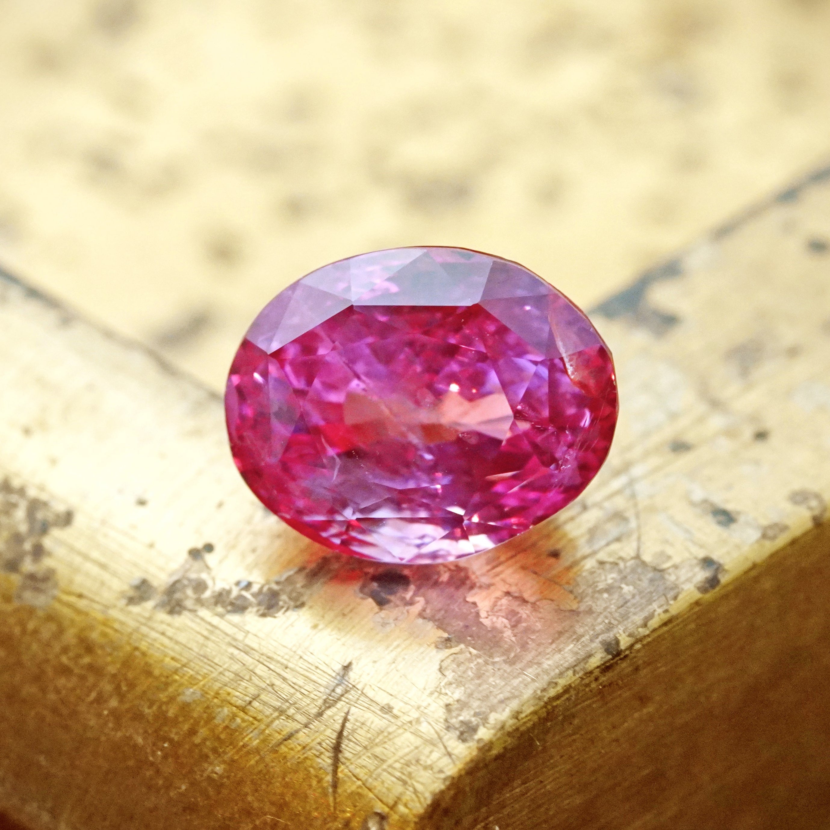 A 4.56-carat oval-shaped Ceylon Padparadscha sapphire, featuring a clean orangy-pink to pink-orange hue, measuring 9.89 x 7.86 x 6.69 mm, with no evidence of heat treatment, accompanied by an AGL certificate number 1144014, presented by Jogani.