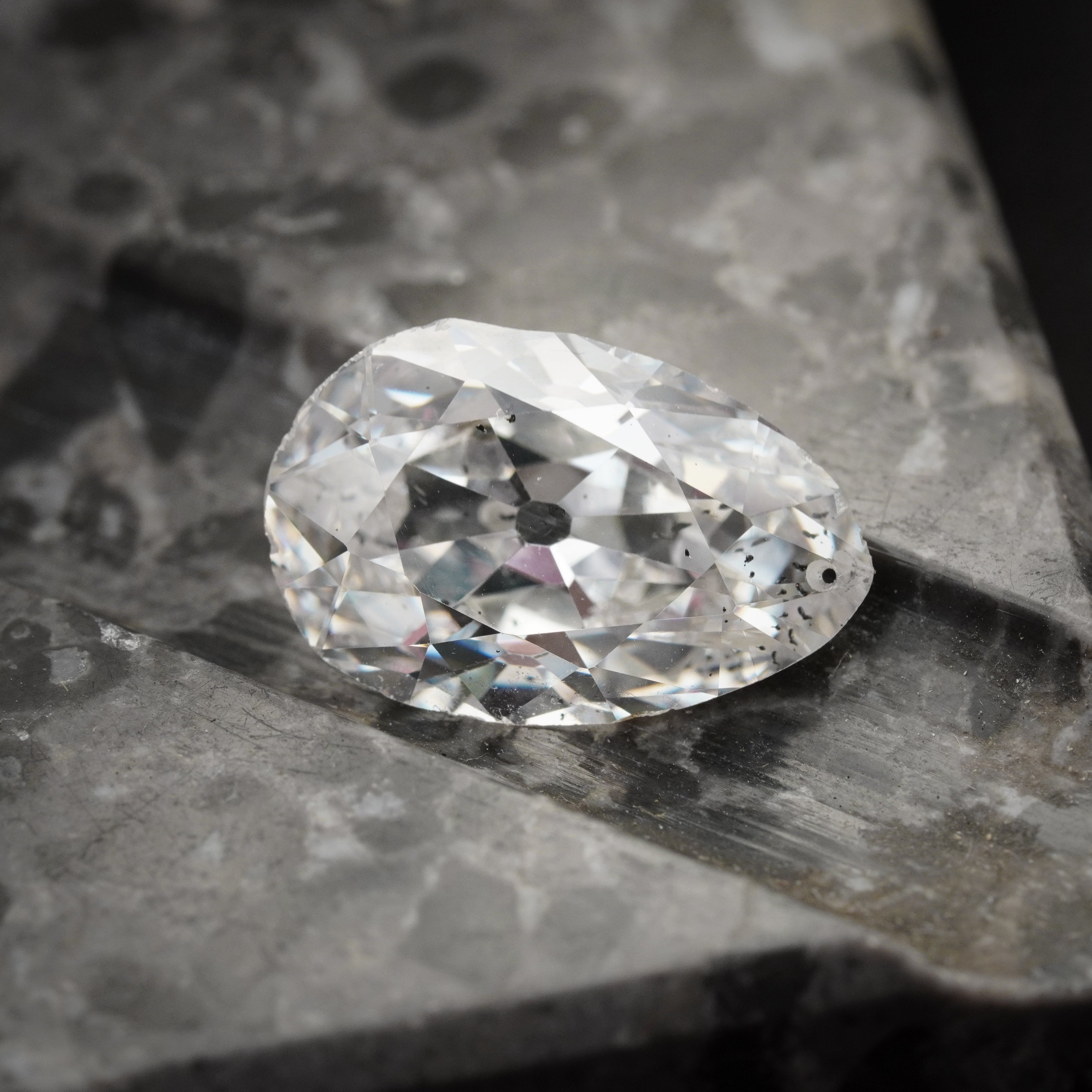 Close-up of a 5.61 ct pear-cut white diamond with G color and I1 clarity, highlighting its elegant shape and natural brilliance. GIA-certified, from Jogani.