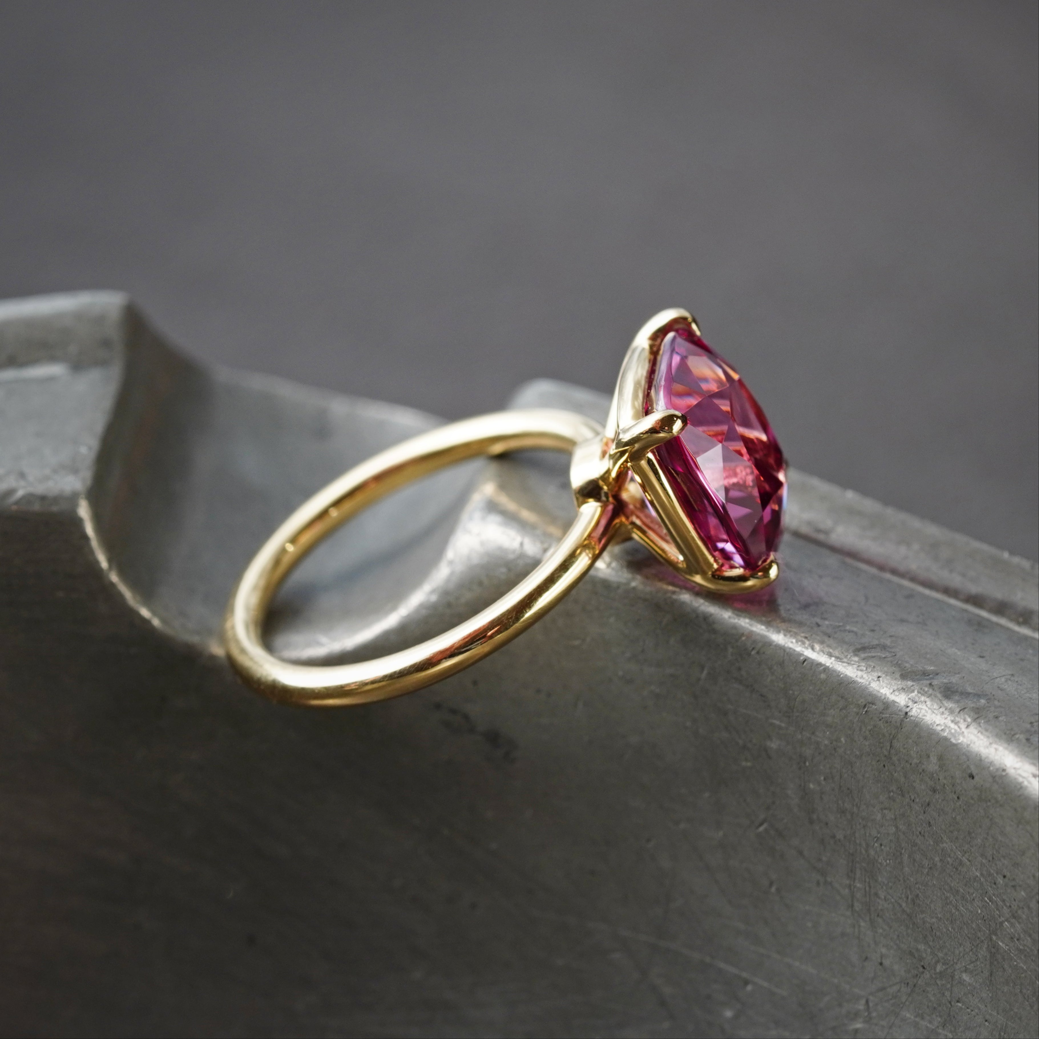 Jewelry designers and collectors take note—this no-heat, cushion-cut Burma spinel (5.76 ct) in a luxurious 18K gold setting is a rare find, hand-selected by Jogani.