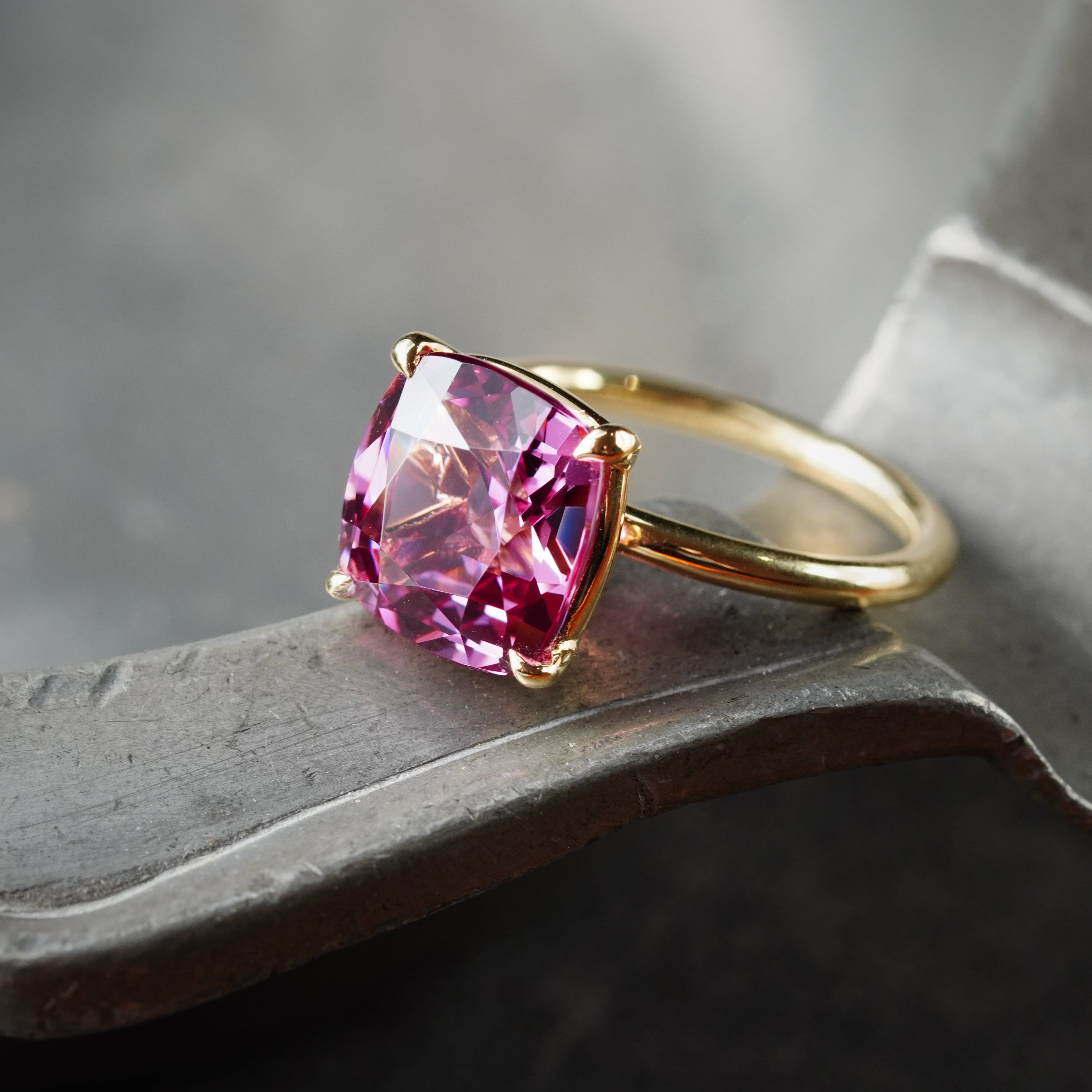 This exquisite 5.76 ct no-heat Burma spinel, cushion-cut for maximum brilliance, is masterfully set in 18K gold. Available exclusively at Jogani, a trusted name in fine gemstones.