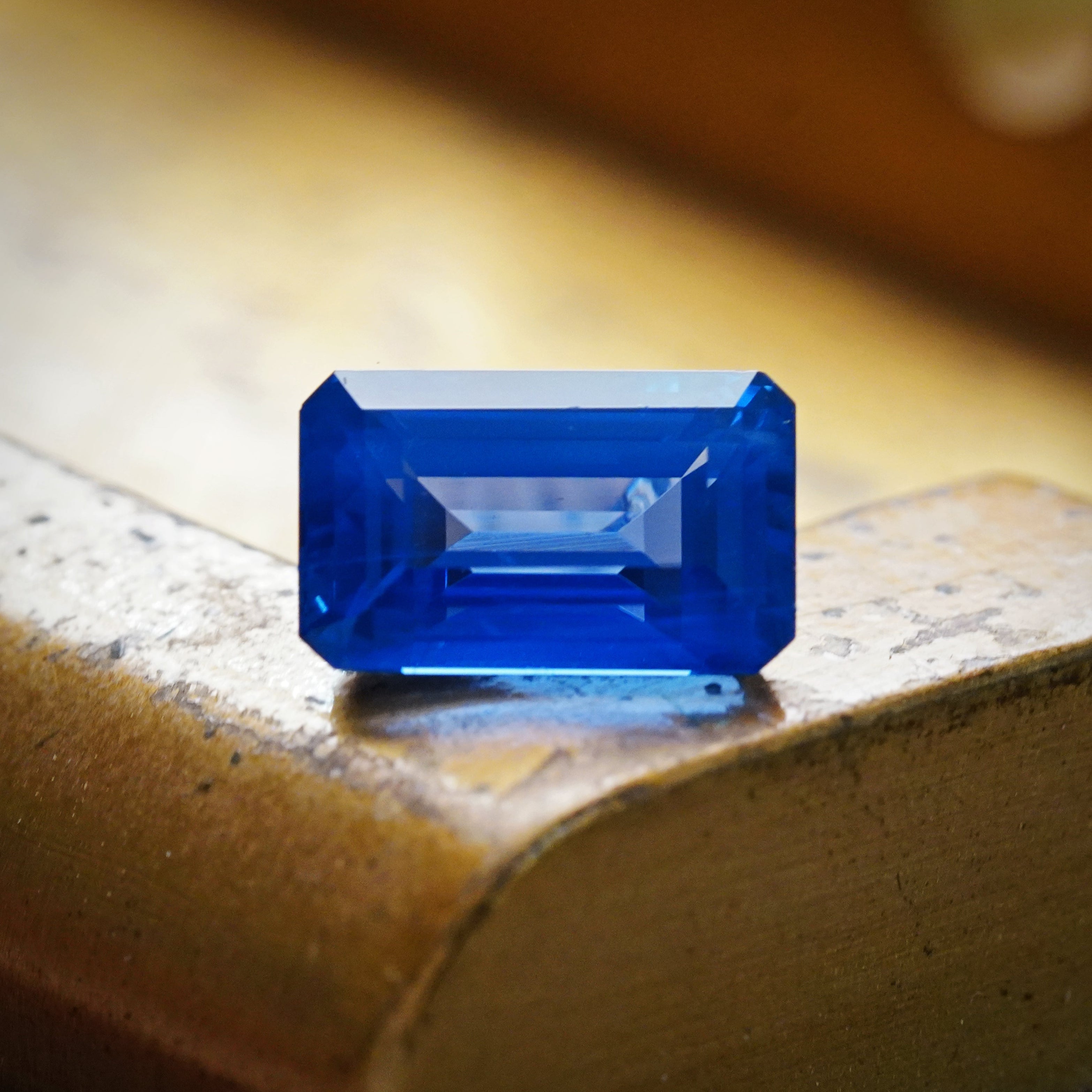 The 6.19-carat Ceylon sapphire displayed under natural lighting, emphasizing its vibrant blue color and step-cut design, by Jogani.