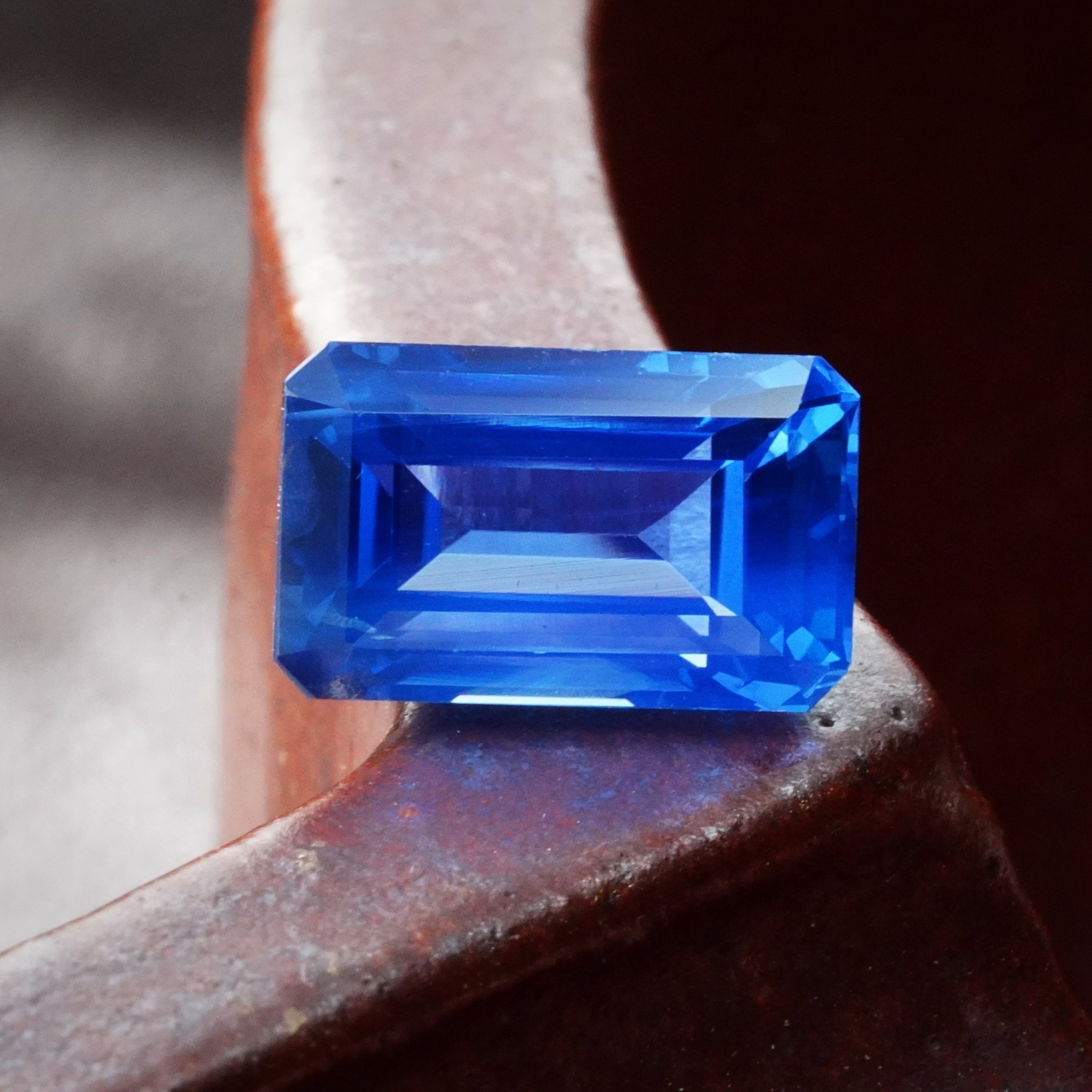 A detailed view highlighting the octagonal step-cut facets of a 6.19-carat Ceylon sapphire, showcasing its clean clarity and rich blue hue, by Jogani.