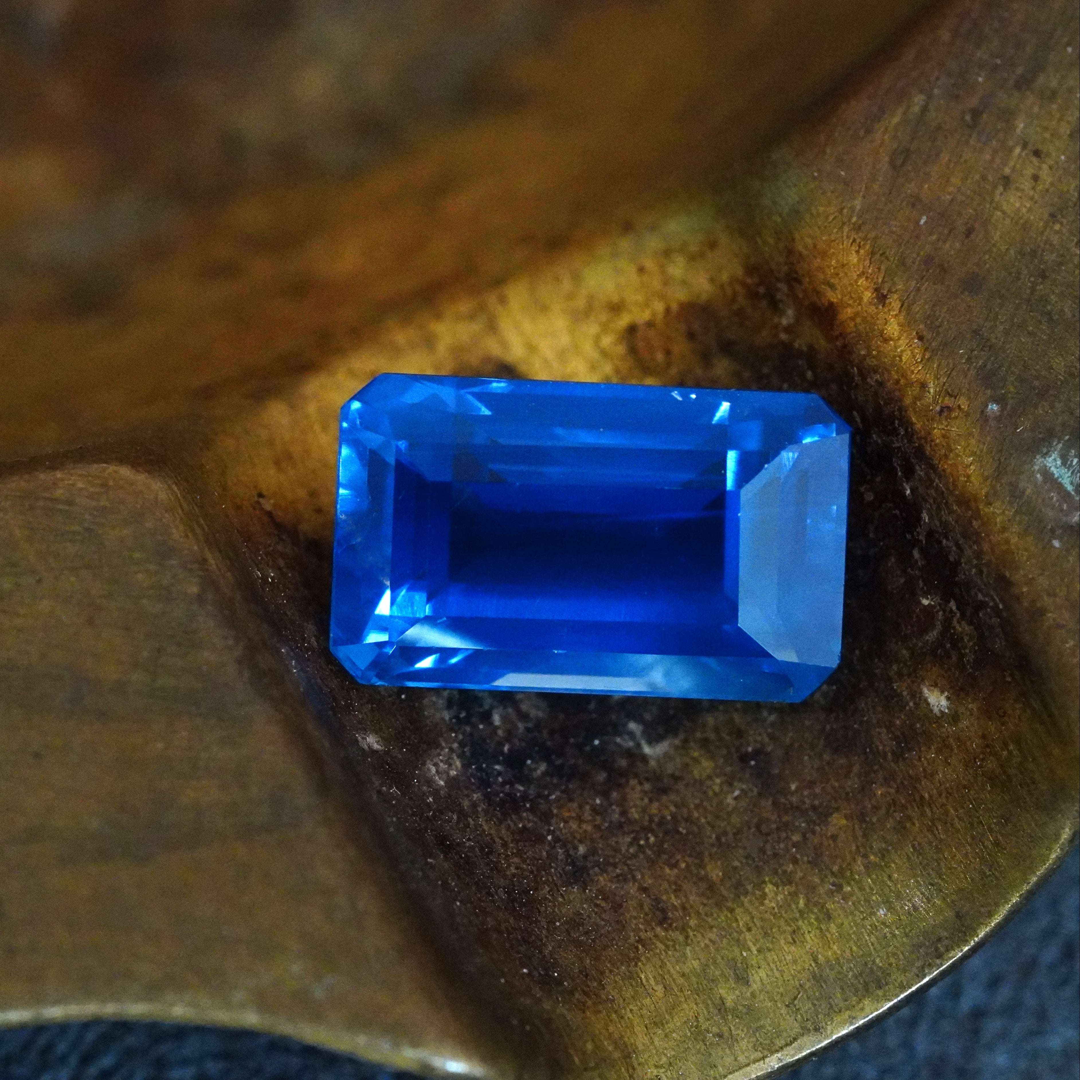 A detailed view highlighting the octagonal step-cut facets of a 6.19-carat Ceylon sapphire, showcasing its clean clarity and rich blue hue, by Jogani.