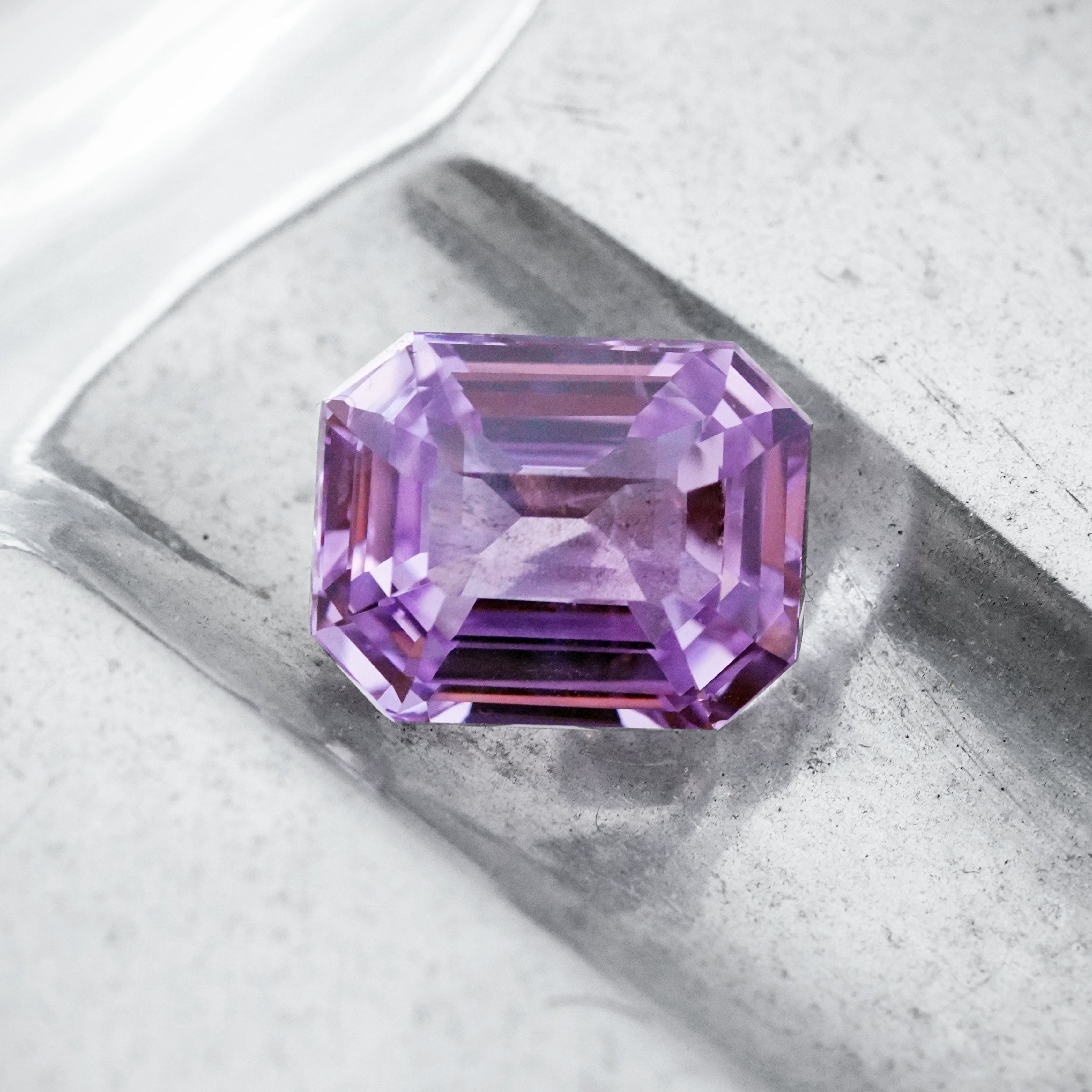 Exquisite 7.01 ct no-heat Ceylon sapphire in a step cut, displaying a striking lavender hue. Sold by Jogani, perfect for fine jewelry and investment.