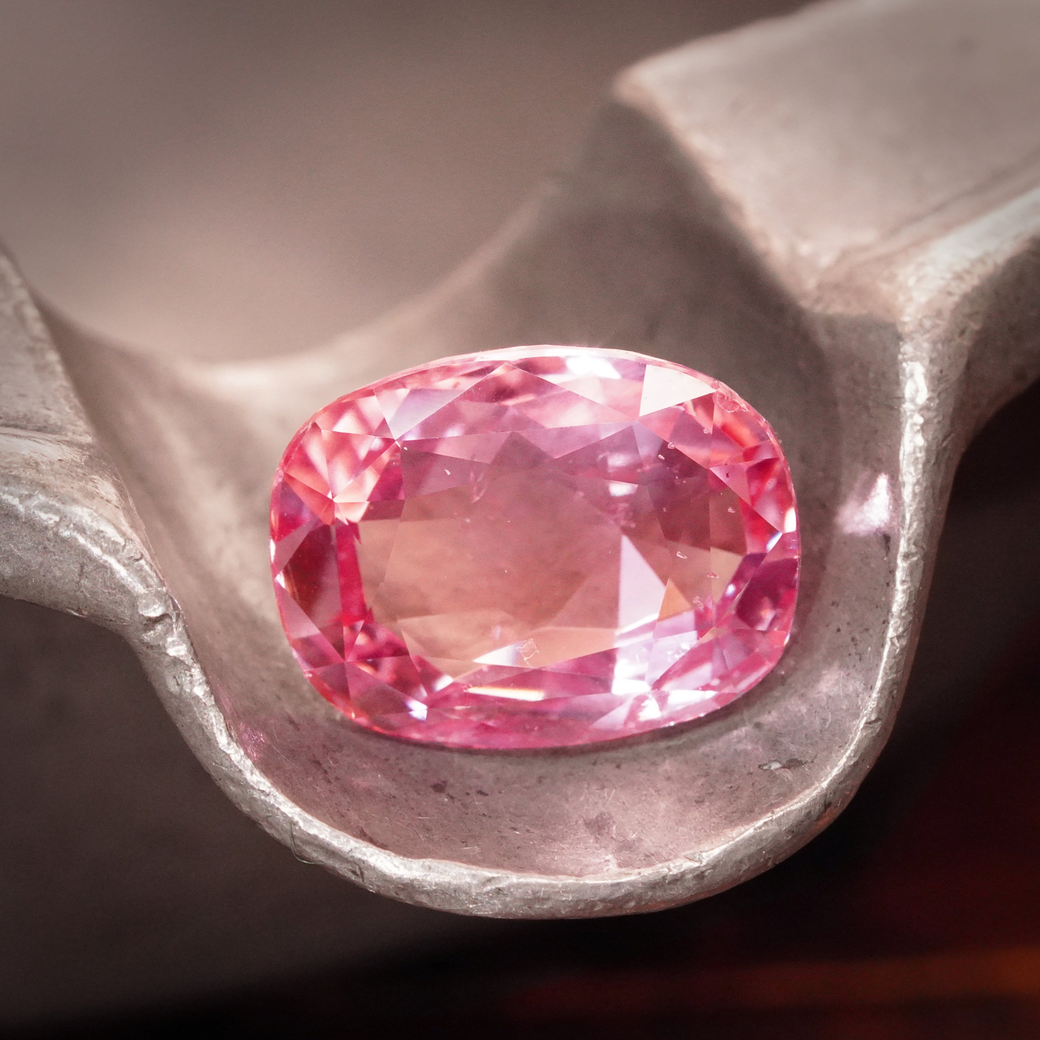 Jogani presents an exceptional 8.06 ct no-heat Padparadscha sapphire, cushion-cut and glowing with a soft, luminous pink—a rare gem for fine jewelry and investment.