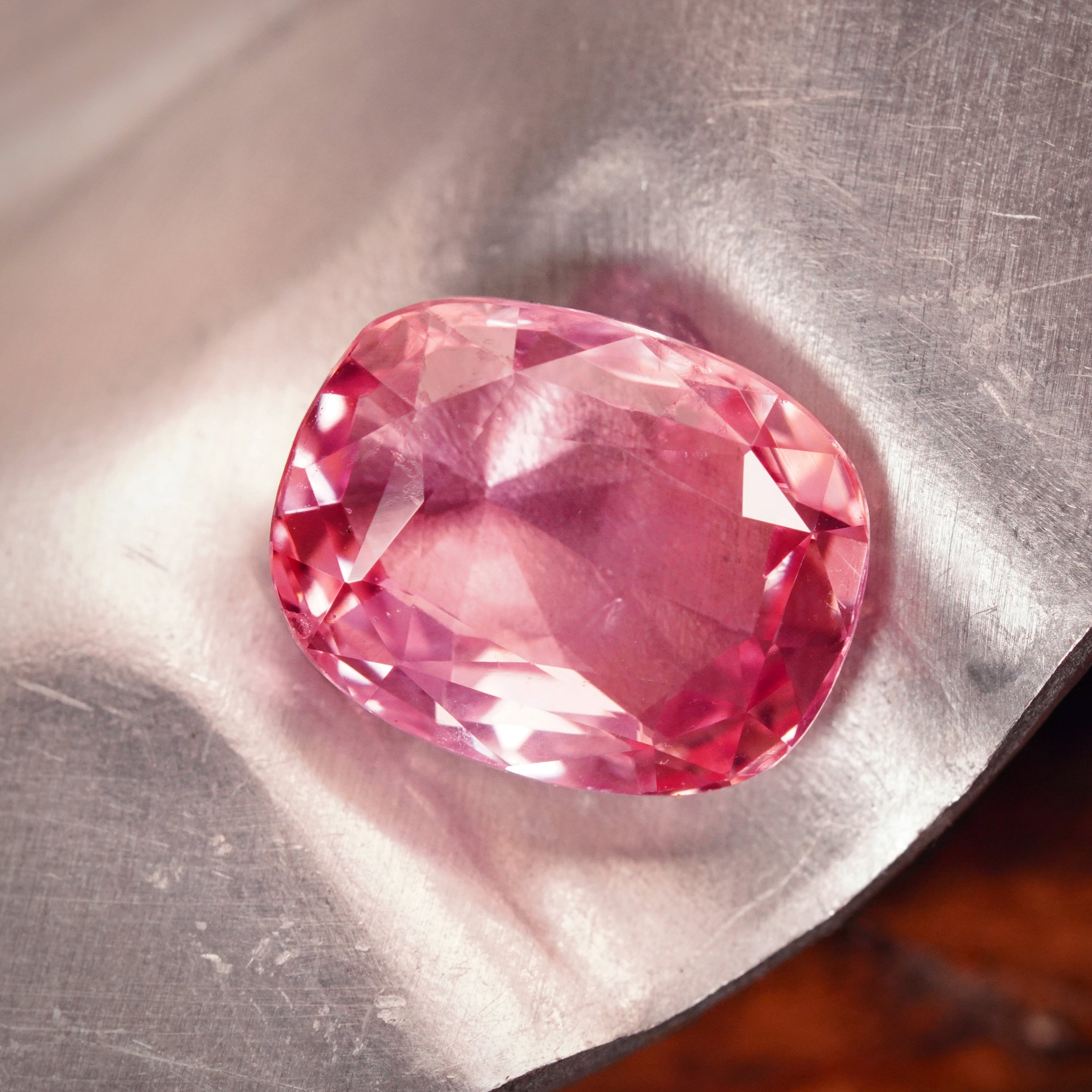 A breathtaking 8.06 ct cushion-cut Padparadscha sapphire from Ceylon, displaying a rare pink hue. This no-heat treasure, available with Jogani, is a must-have for collectors.