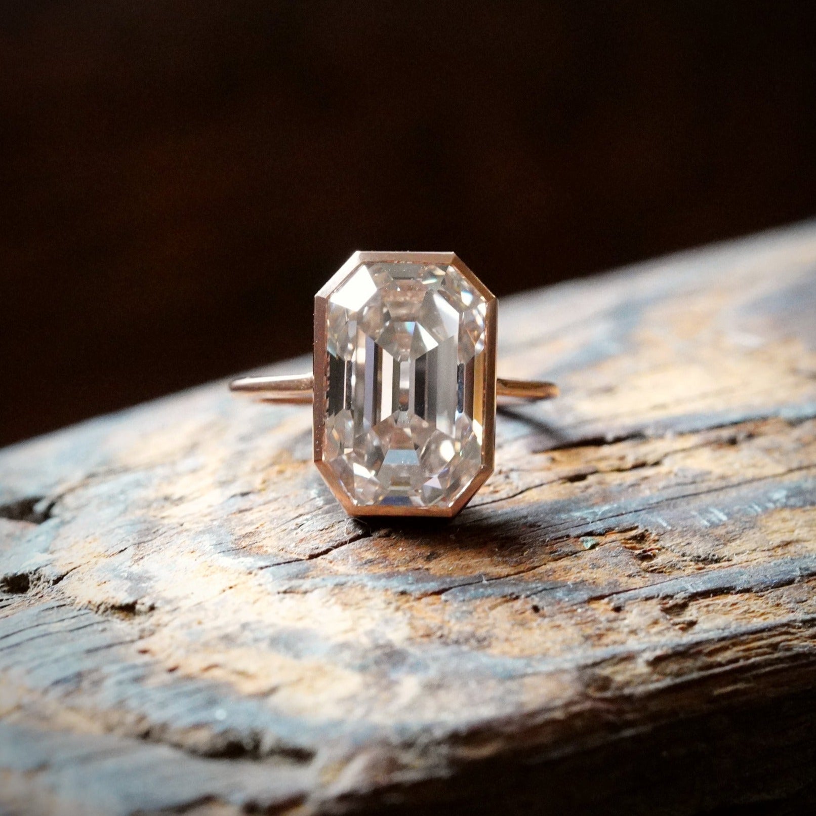 An exquisite 8.06 ct Step Cut Diamond Ring, crafted by Jogani in rose gold and platinum. With a faint brown hue and VVS2 clarity, this bezel-set masterpiece is a collector’s dream.