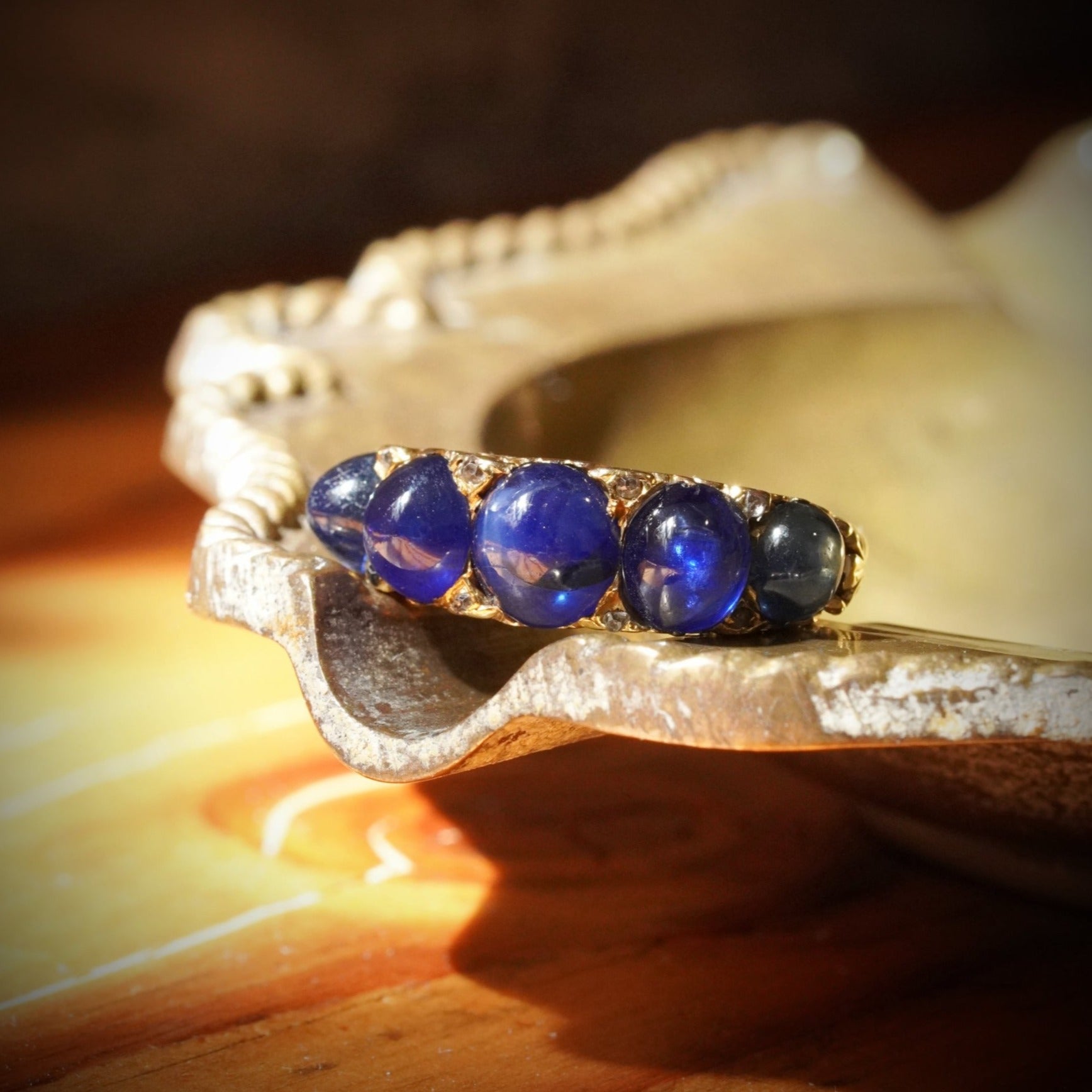 Victorian Azure Magic: A Five-Sapphire Ring Set in 18K Yellow Gold