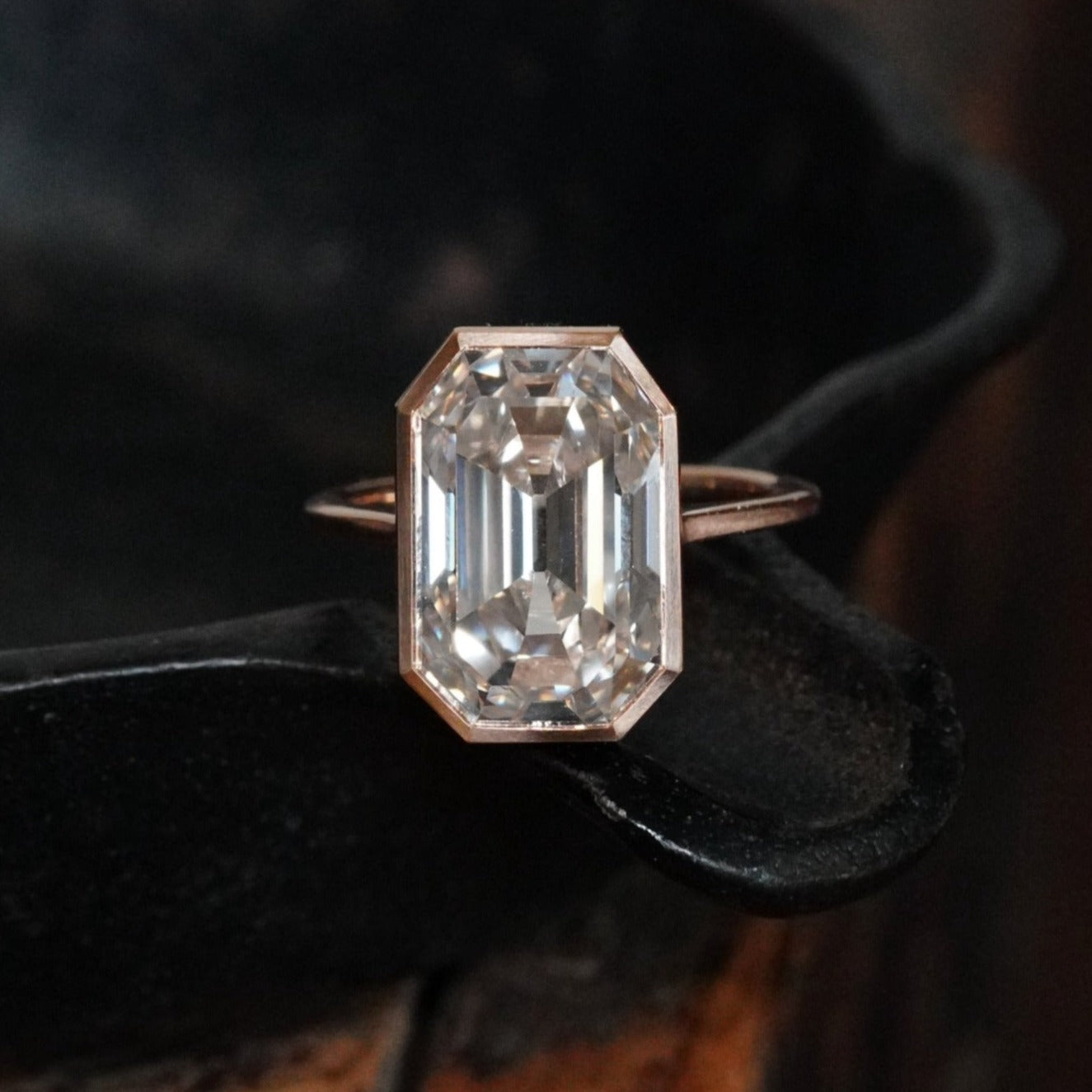 An exquisite 8.06 ct Step Cut Diamond Ring, crafted by Jogani in rose gold and platinum. With a faint brown hue and VVS2 clarity, this bezel-set masterpiece is a collector’s dream.