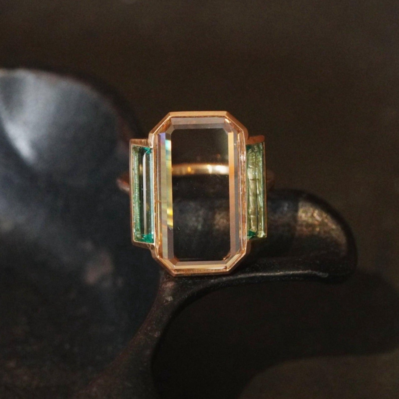 Deco-inspired portrait diamond ring with step cut emeralds in 20k rose gold
